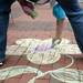 Lynnie B uses chalk to draw artwork in the diag of Michigan campus during the seventh annual P.E.A.C.E. Day on Sunday. "It's a step in the right direction to bring people together and spread peace around," says Kevin Szawala, a.k.a Mr. Peace,  who has run the event for seven years. Daniel Brenner I AnnArbor.com